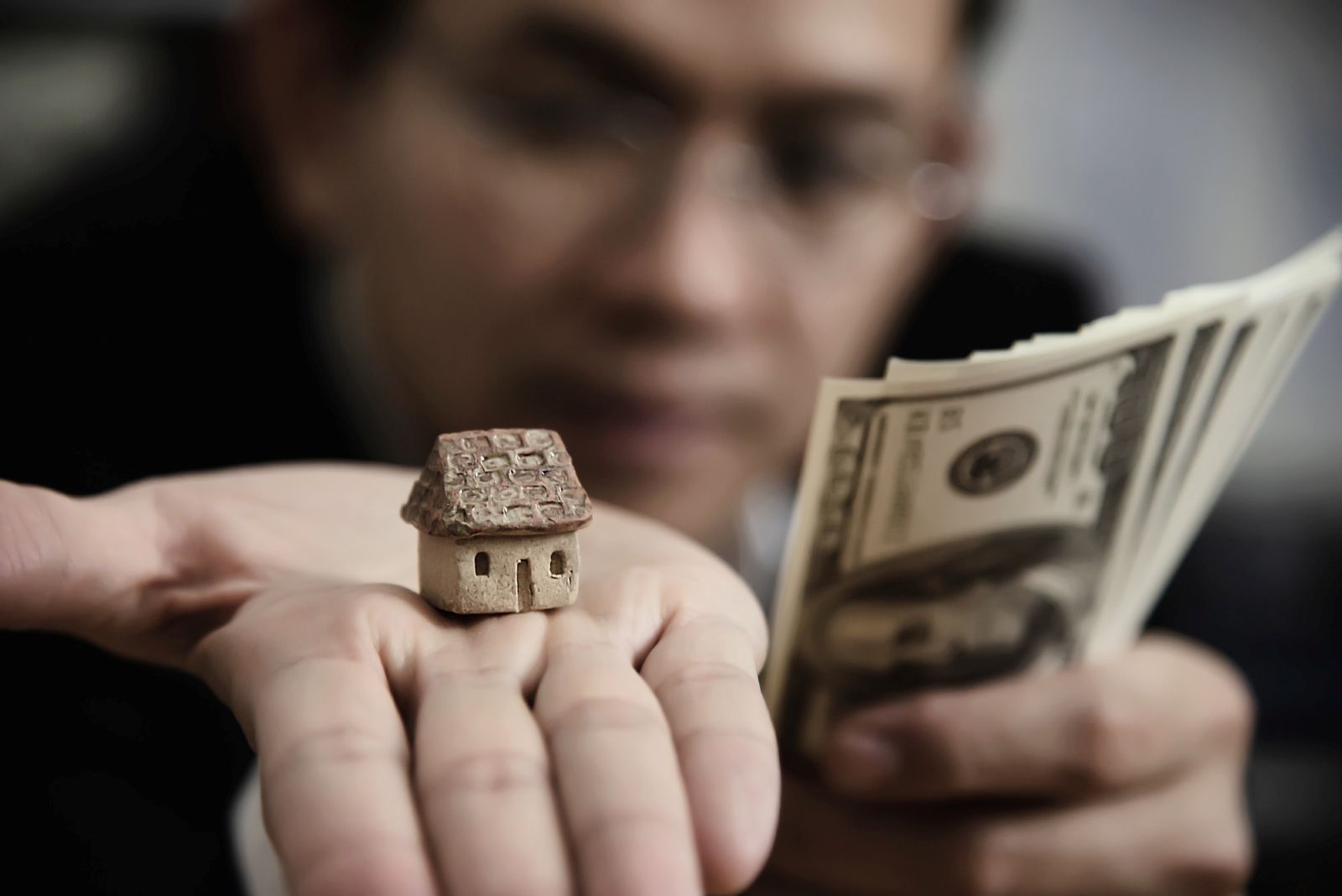 Wealthy property owner comparing real estate asset value and cash liquidity illustrating accessing equity through Singapore bridging loans